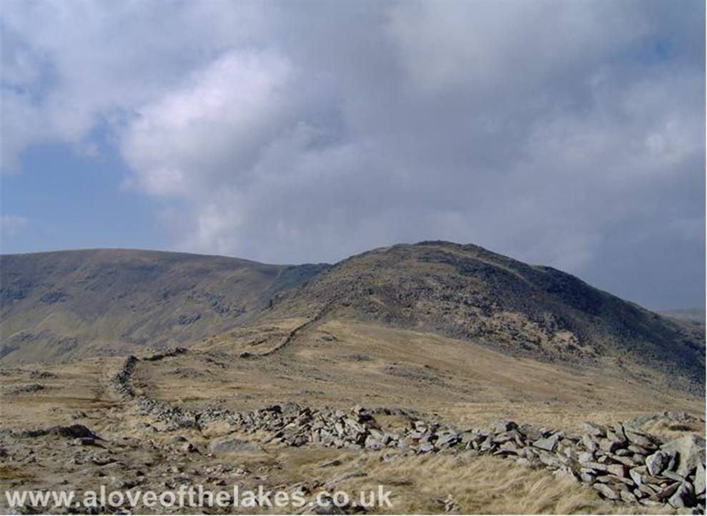 A love of the Lakes - From High Pike the wall becomes a bit more broken up however it can still act as a sure guide towards the summit of Dove Crag. From here on the 
horseshoe becomes more apparent, here the head of Fairfield can be seen
