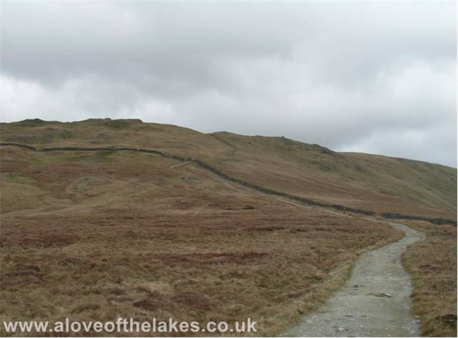 A love of the Lakes - The path leads to a wall stile that gives access to the summit approach to Yoke