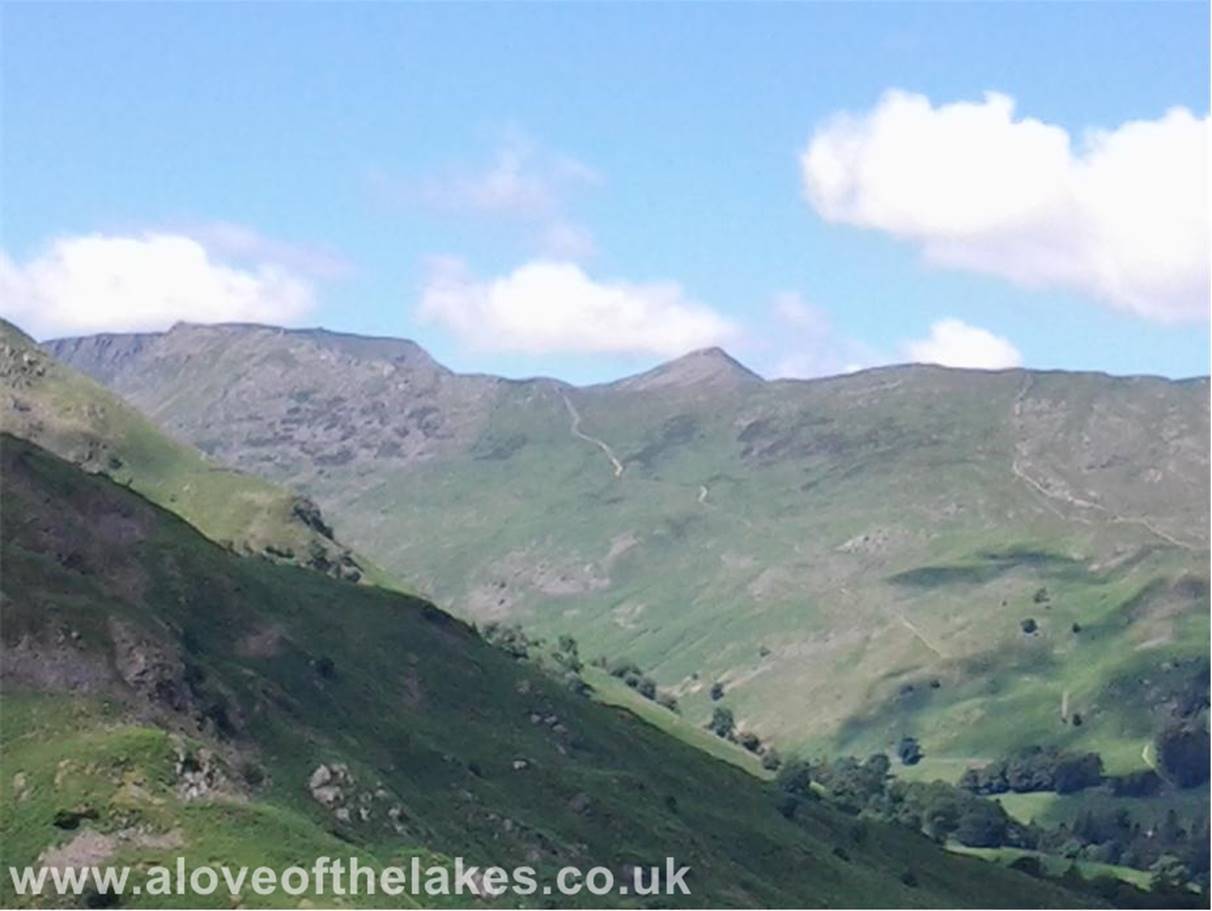 Looking over to Helvellyn and the sharp peak of Catstye Cam. The path leading up to The Hole in the Wall can be clearly seen