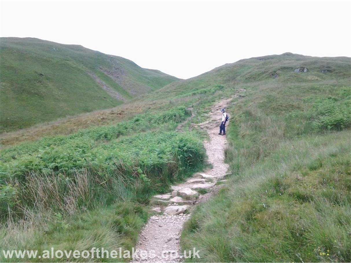 The path is clearly defined and passes through a short ravine between Rake Crag and Stony Rigg