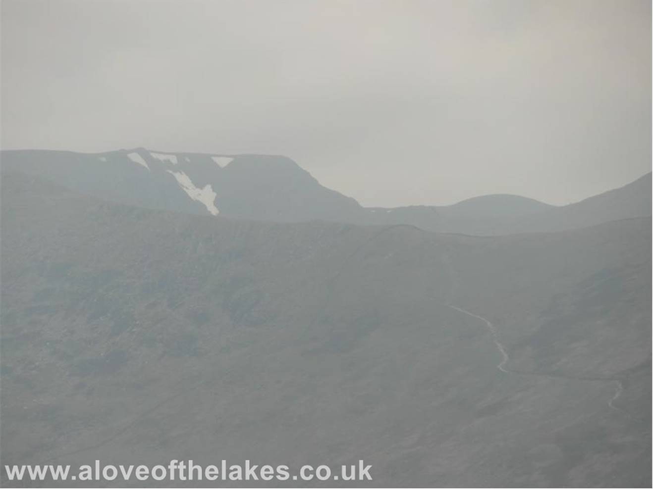 Looking through the haze towards a snow capped Helvellyn