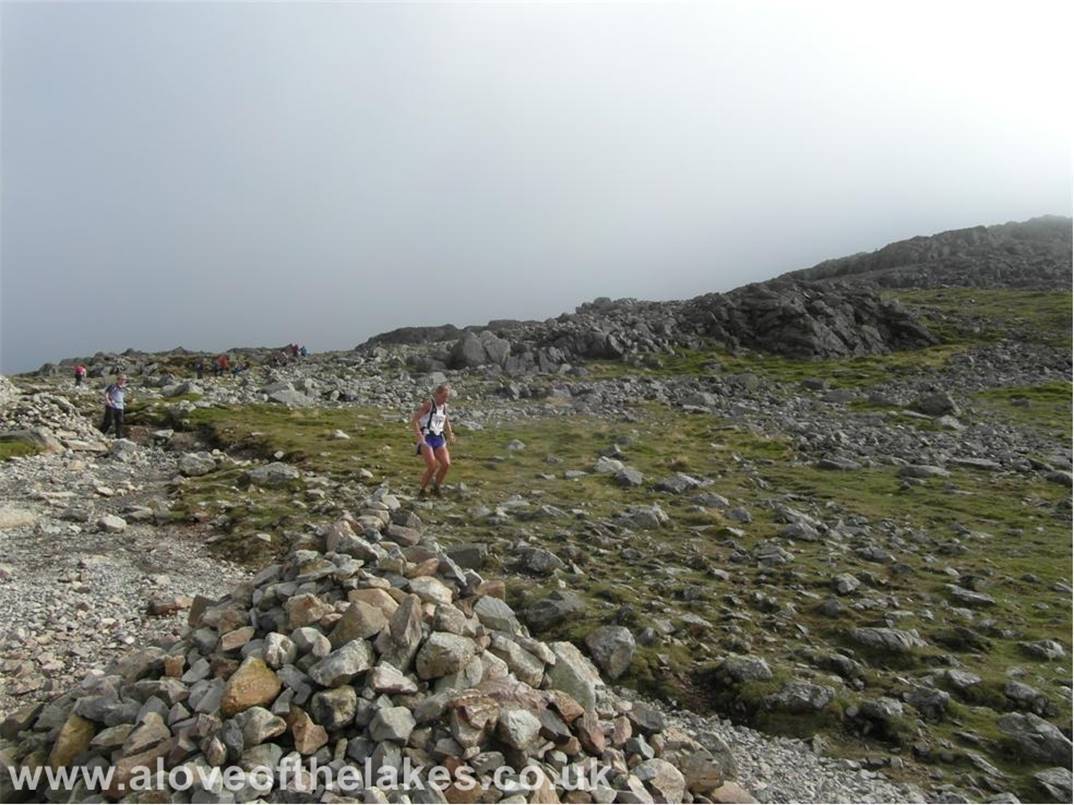Further up the track and this woman (part of a fell race today) was absolutely flying down over the boulders