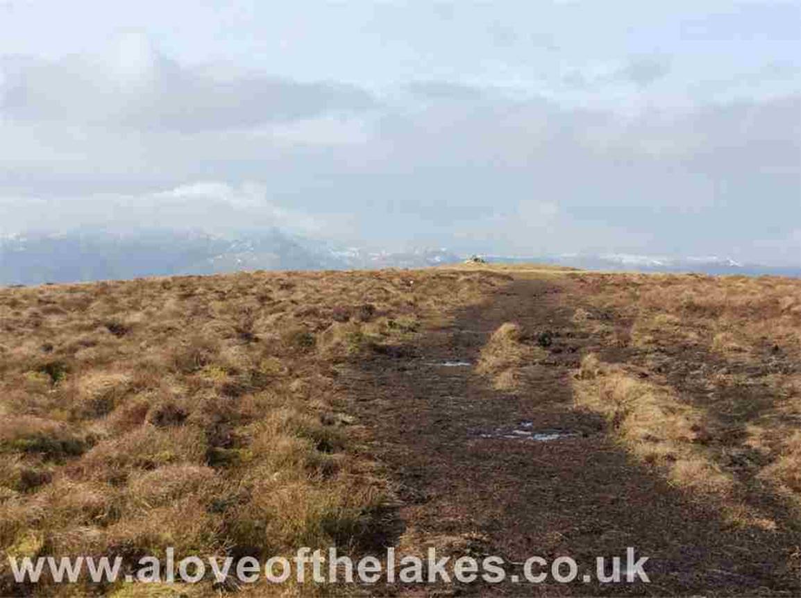 Carry on for about another 10 minutes or so over very muddy terrain and the summit cairn comes into view