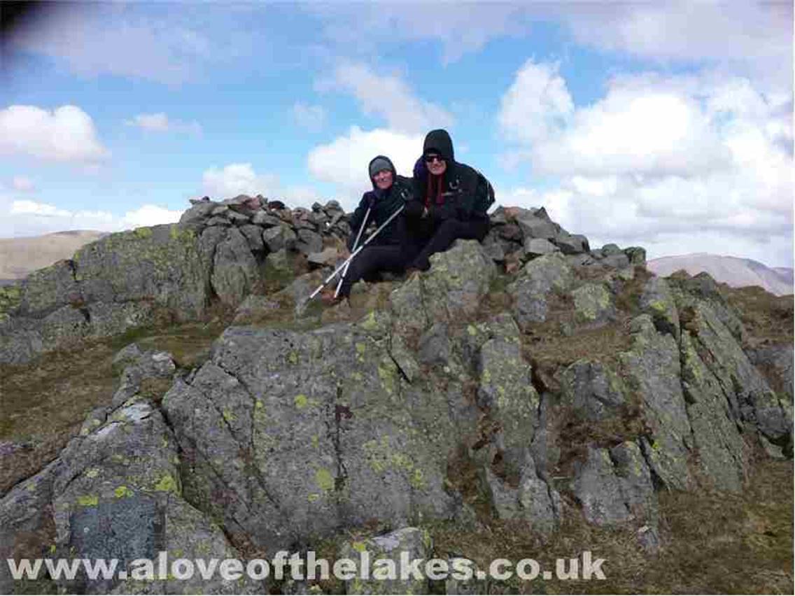 The summit shelter cairn provides some respite from the biting cold wind