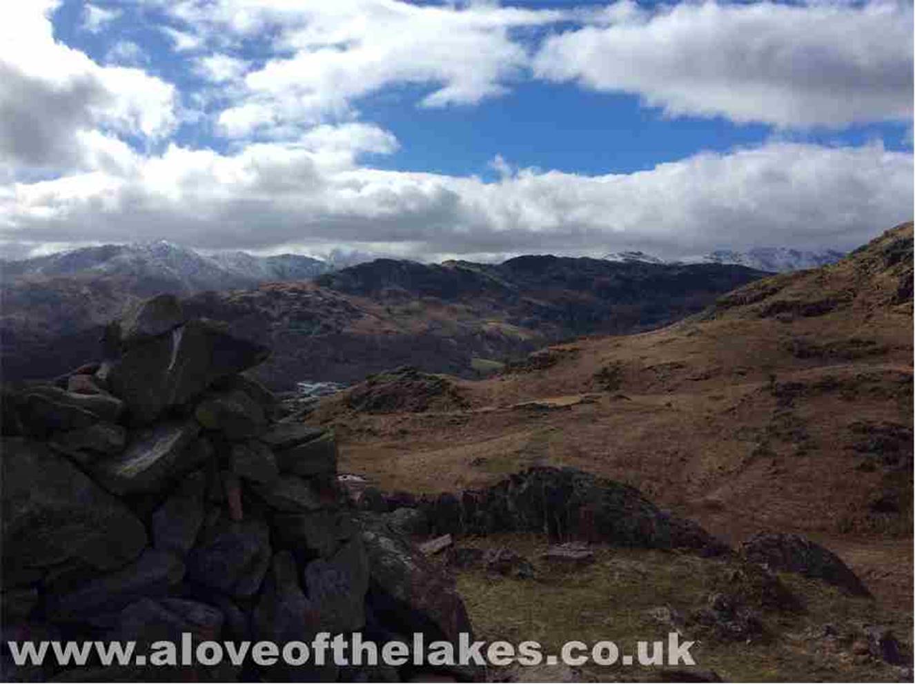 Follow the path from the gap that leads you gently to ascend Huntingstile Crag. The view from the small cairn here across to the Coniston
range of fells
