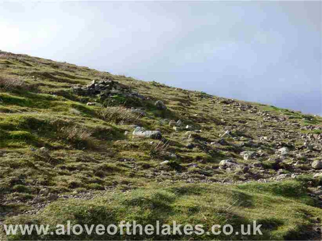 Watch out for a series of marker cairns nearer to the summit that swing round left. From this point there is a short
journey over stony ground
