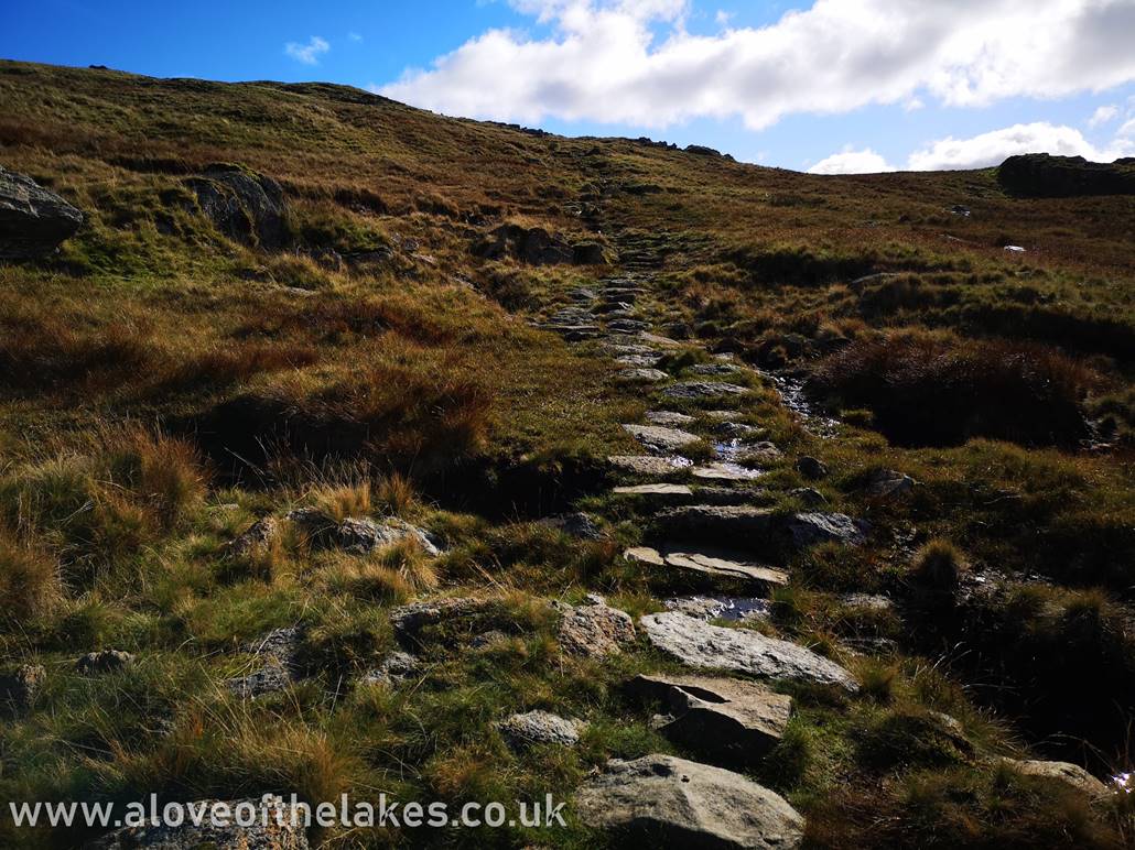 Further on up and the steeper path is stepped as it heads towards the base of the summit
