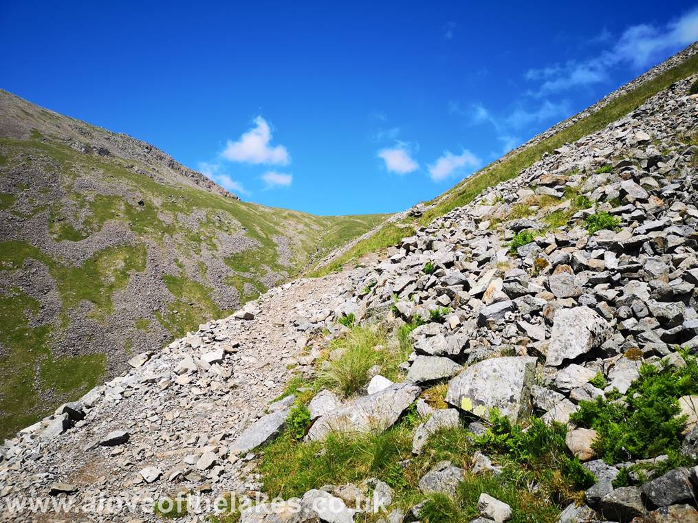 As Beck Head is approached the scree path levels out a little. The route of ascent to Kirk Fell via Rib End 
is seen on the left
