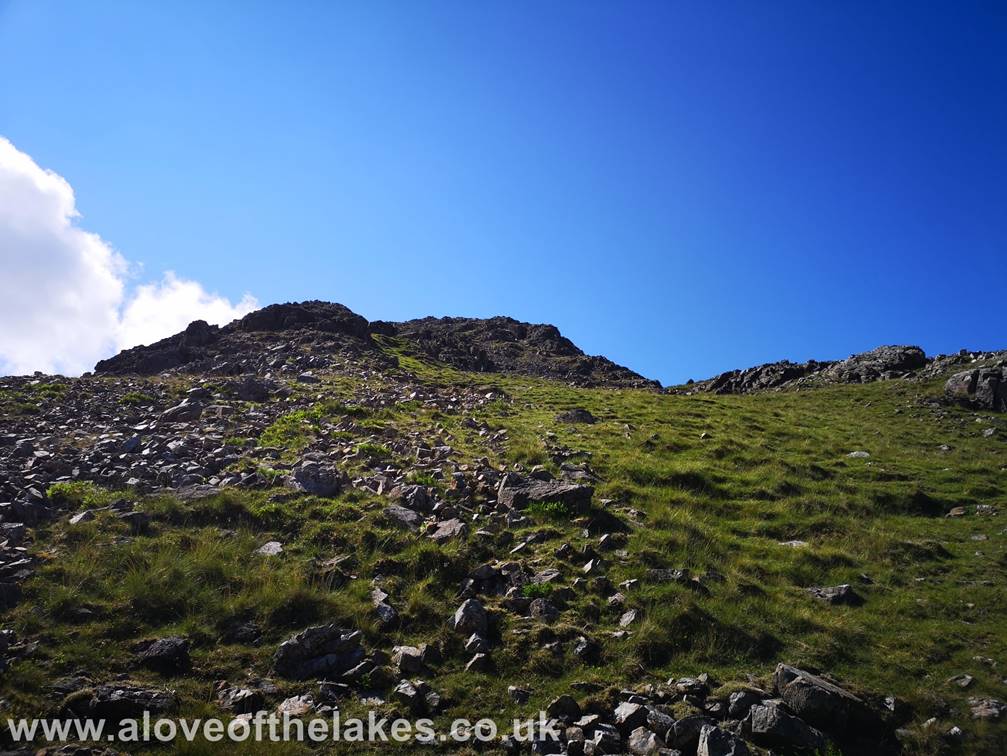 After passing through the initial band of rock a grass path leads up to Kirk Fells North top, but this can be 
bypassed by keeping left on a decent grass track that leads to the true summit on the South top
