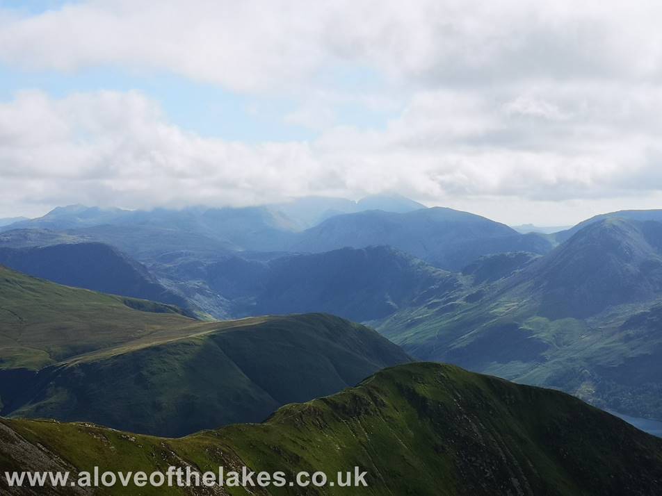Looking over the ridge line from between Wandope and Whiteless Pike to the Scafell group