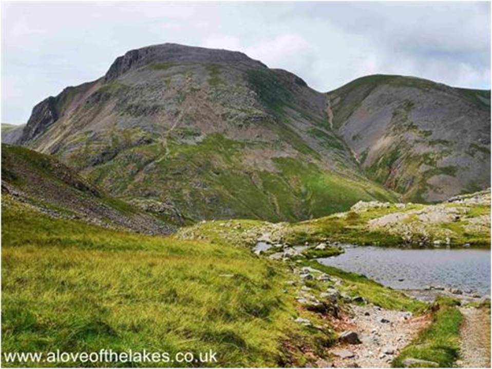 Along the shoreline of the Tarn and revealed in all its glory  the majestic site of the Breast Route track up to Great Gable summit