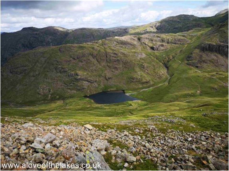 The path looks ominous but is stepped through the scree run to assist with the climb, whilst it is arduous it is not in any way dangerous and there are no difficulties in navigation. Styhead Tarn below
