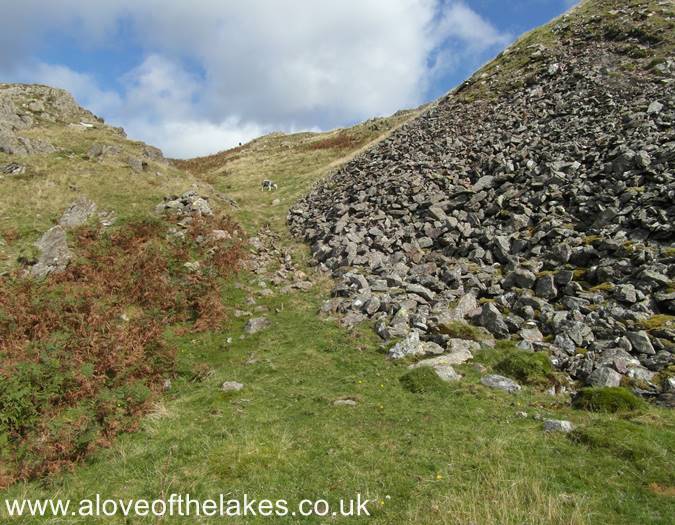 The path threads between two areas of rock