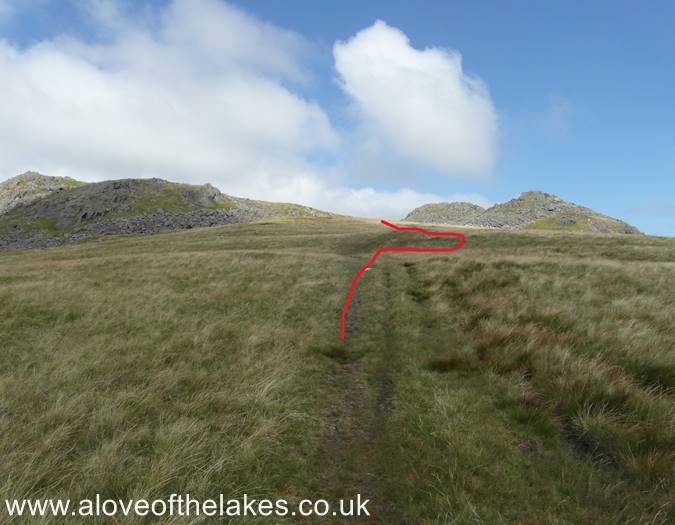 The track passes through a dip between two areas of high ground